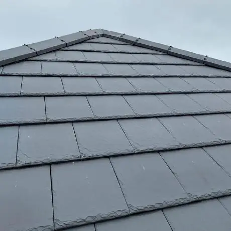 Roofing near Ormskirk: new grey tiles on a roof ridge