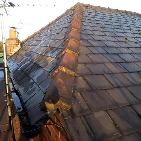 Roofing near Orrell: tiled roof hip and chimney catching the evening sun