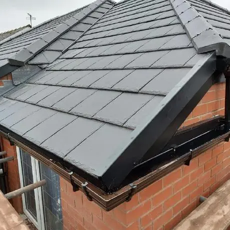 new grey roof with black fascias and guttering on a brick extension