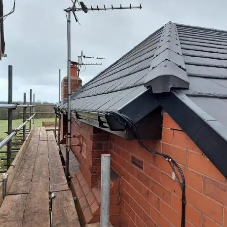 Roofing near Atherton: new roof verge and guttering on a brick bungalow