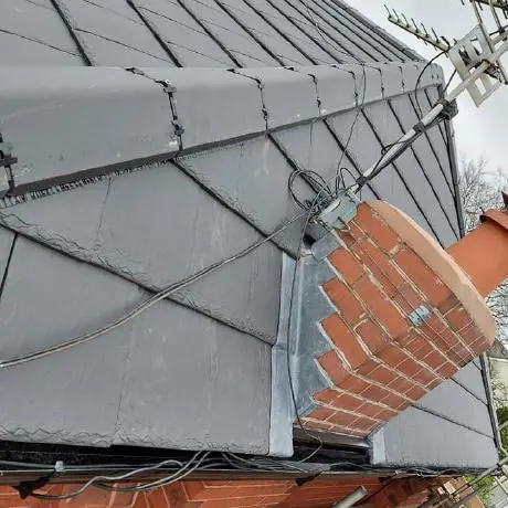 Roofing near Westhoughton: hip end of a new grey tiled roof