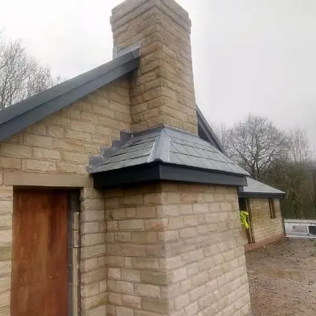 Roofing near Billinge: stone chimney and slate roof detail