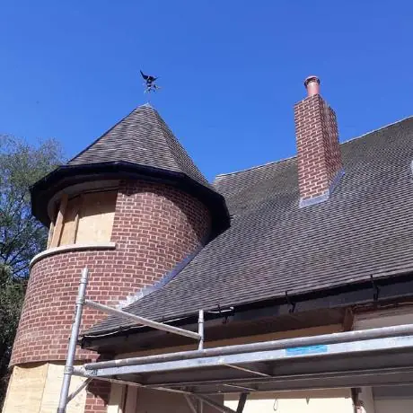 Roofing in Chorley: turret roof and chimney on a house with new tiles