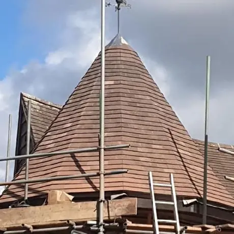Roofing near Hindley: conical turret roof surrounded by scaffolding